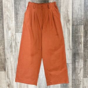 Women’s orange rust pleated trousers